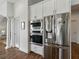 Stainless steel refrigerator, microwave, and oven with white cabinets at 1547 Cordgrass Way, Lakeland, FL 33813