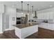 Kitchen island with granite countertop, stainless appliances and pendant lights at 1547 Cordgrass Way, Lakeland, FL 33813