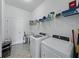 Well-equipped laundry room features a utility sink, washer, and dryer at 1547 Cordgrass Way, Lakeland, FL 33813