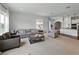 Open-concept living room flows seamlessly to the kitchen area with modern furnishings at 1547 Cordgrass Way, Lakeland, FL 33813