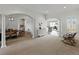 Open-concept living room with carpet and views to the dining room, kitchen, and other living areas at 1547 Cordgrass Way, Lakeland, FL 33813