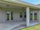 Spacious covered patio area with access to the home through French doors, and a view of the backyard at 1547 Cordgrass Way, Lakeland, FL 33813
