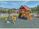 Community playground featuring swings, slide, climbing structure, benches, and a safety surface at 1547 Cordgrass Way, Lakeland, FL 33813