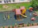 A fun playground with a slide, swings, and climbing structure on a safe, cushioned surface at 1547 Cordgrass Way, Lakeland, FL 33813
