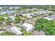 Aerial view of the community featuring a serene lake, charming homes, and lush greenery at 1602 Tally Ho Dr, Lakeland, FL 33810
