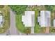 Aerial shot of a home with pristine green lawn, complemented by nearby houses and a neighborhood street at 1602 Tally Ho Dr, Lakeland, FL 33810