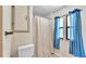 Functional bathroom with a shower-tub combination and floral wallpaper at 1602 Tally Ho Dr, Lakeland, FL 33810