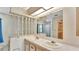 Well-lit bathroom with double sinks, neutral countertops, and a large vanity mirror at 1602 Tally Ho Dr, Lakeland, FL 33810