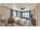 Calm bedroom featuring a cozy bed, soft blue accents, and bright natural light at 1602 Tally Ho Dr, Lakeland, FL 33810