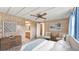 Serene bedroom with wood-paneled walls, comfortable seating, and an ensuite bathroom at 1602 Tally Ho Dr, Lakeland, FL 33810