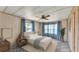 Staged bedroom with carpet, furniture, ceiling fan and several windows at 1602 Tally Ho Dr, Lakeland, FL 33810