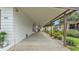 Long carport with covered parking, adjacent to a lush landscaped yard and the home at 1602 Tally Ho Dr, Lakeland, FL 33810