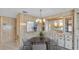 Dining room with wood paneled walls, neutral colored carpet, and modern art at 1602 Tally Ho Dr, Lakeland, FL 33810
