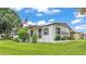 Charming home exterior featuring a manicured lawn, shrubbery, and flagpole with American flag at 1602 Tally Ho Dr, Lakeland, FL 33810
