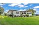 Well-maintained home exterior with green lawn, mature bushes, and neat landscaping at 1602 Tally Ho Dr, Lakeland, FL 33810