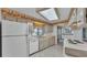 Kitchen featuring white cabinets, a window over the sink, and updated appliances at 1602 Tally Ho Dr, Lakeland, FL 33810