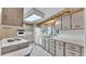 Kitchen featuring white cabinets, a window over the sink, and updated appliances at 1602 Tally Ho Dr, Lakeland, FL 33810