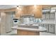 Bright kitchen features white cabinets, laminate countertops and a central island with cooktop at 1602 Tally Ho Dr, Lakeland, FL 33810