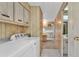 Clean laundry area with a washer and dryer, built-in cabinets and view of the kitchen at 1602 Tally Ho Dr, Lakeland, FL 33810