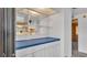 Charming butler's pantry between the living room and kitchen with blue counters and shelving at 1602 Tally Ho Dr, Lakeland, FL 33810