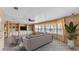 Bright living room with wood paneled walls, built-in shelving, and modern seating at 1602 Tally Ho Dr, Lakeland, FL 33810