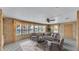 Comfortable living room featuring wood paneled walls, large windows, and neutral colored furniture at 1602 Tally Ho Dr, Lakeland, FL 33810