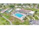 Aerial view of the community pool, clubhouse, tennis courts, and parking area at 1602 Tally Ho Dr, Lakeland, FL 33810
