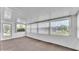 Enclosed sunroom featuring neutral carpet and multiple windows offering plenty of natural light at 1602 Tally Ho Dr, Lakeland, FL 33810