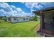 Spacious backyard with green grass and a screened-in porch at 1608 Colonnades N Cir, Lakeland, FL 33811