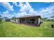 Expansive backyard featuring a screened-in patio at 1608 Colonnades N Cir, Lakeland, FL 33811