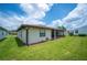 Green backyard featuring a screened-in porch at 1608 Colonnades N Cir, Lakeland, FL 33811