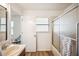 Bathroom featuring a shower-tub combination with sliding glass doors and a modern vanity at 1608 Colonnades N Cir, Lakeland, FL 33811