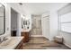 Clean and bright bathroom with double sinks, a shower, and a window for natural light at 1608 Colonnades N Cir, Lakeland, FL 33811
