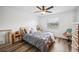 Cozy bedroom with ceiling fan, natural light, hardwood floors, and comfortable decor at 1608 Colonnades N Cir, Lakeland, FL 33811