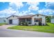 Well-kept home with a landscaped yard, a screened-in porch, and an attached garage on a sunny day at 1608 Colonnades N Cir, Lakeland, FL 33811