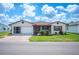 Charming single-story home featuring a screened-in porch, well-maintained lawn, and attached two-car garage at 1608 Colonnades N Cir, Lakeland, FL 33811