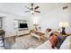 Comfortable living room featuring neutral decor, a ceiling fan, and plenty of natural light at 1608 Colonnades N Cir, Lakeland, FL 33811
