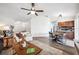 Open living space with hardwood floors combining living, dining, and kitchen areas for modern living at 1608 Colonnades N Cir, Lakeland, FL 33811