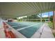 A view of the shuffleboard courts, covered with overhead shade, with many lanes and benches for onlookers at 1608 Colonnades N Cir, Lakeland, FL 33811