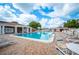 A community swimming pool surrounded by lounge chairs and a brick deck is ready for a refreshing swim at 1608 Colonnades N Cir, Lakeland, FL 33811