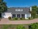 Aerial view of the home highlighting the screened-in porch, brick driveway, and lush landscaping at 184 Melissa Trl, Auburndale, FL 33823