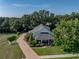 Beautiful home with an expansive front lawn, brick driveway, and inviting covered porch at 184 Melissa Trl, Auburndale, FL 33823
