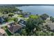 Aerial view showcasing home's location with water access, landscaping, and surrounding neighborhood at 184 Melissa Trl, Auburndale, FL 33823