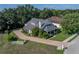 Inviting home with a welcoming front porch, brick driveway, and lush, green landscaping at 184 Melissa Trl, Auburndale, FL 33823