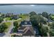 An aerial view of the home emphasizing its lake view, landscaping, and neighborhood setting at 184 Melissa Trl, Auburndale, FL 33823