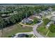 Sprawling property featuring a well-maintained lawn, brick driveway, and mature trees at 184 Melissa Trl, Auburndale, FL 33823