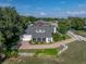 Stunning home with a relaxing screened porch, brick driveway, and lush, green landscaping at 184 Melissa Trl, Auburndale, FL 33823