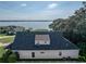 An aerial view showcases the home's roof and the beautiful lake in the background, framed by mature trees at 184 Melissa Trl, Auburndale, FL 33823