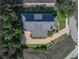 An aerial view of the home showing the roof, driveway, and its position on a spacious lot at 184 Melissa Trl, Auburndale, FL 33823