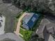 Aerial shot of a property highlighting its roof, driveway, landscaping, and proximity to neighboring homes at 184 Melissa Trl, Auburndale, FL 33823